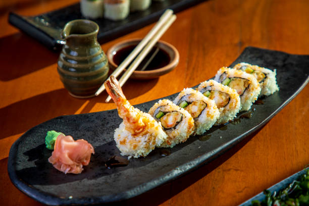 Shrimp tempura rolls with wasabi and ginger, soy sauce on the side Shrimp tempura served in a row, with wasabi and ginger on a plate, soy sauce and chopsticks on the side Tempura Prawns stock pictures, royalty-free photos & images