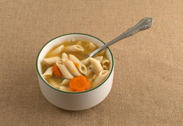 istock Penne pasta soup in a bowl with a spoon 1307540620