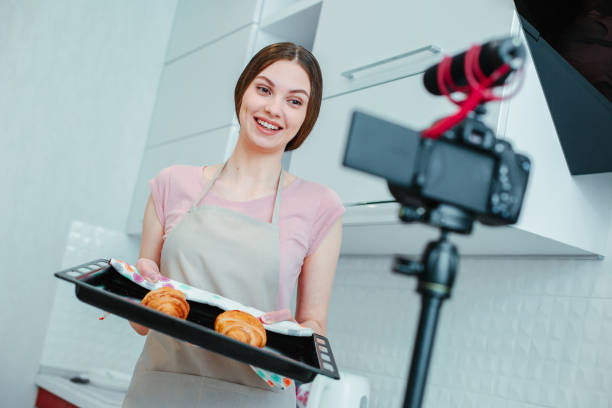istock Enthusiastic lady recording her recipes on the camera 1307540827