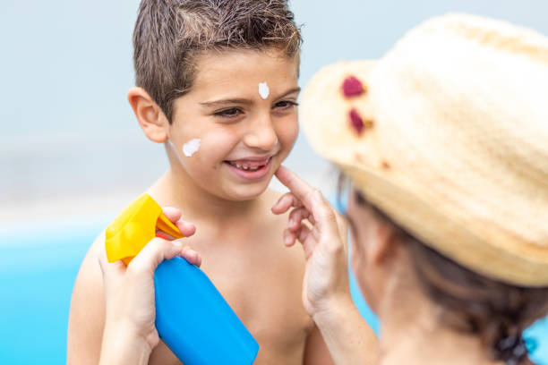 istock Mother aplying sunscreen to her son on a summer day 1307541007