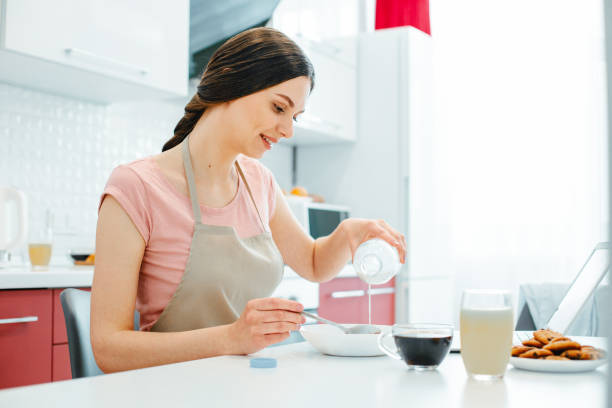 istock Calm beautiful lady having meal at home 1307542179