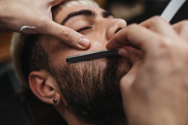 istock Barber Giving A shaving in His Shop 1307542310