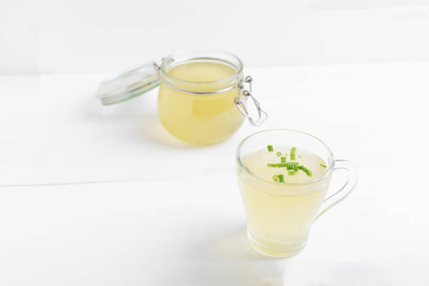 istock Homemade bone broth with leek in glass cup 1307542879