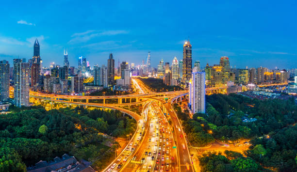 istock Shanghai skyline and buildings with highway at sunset. 1307544955