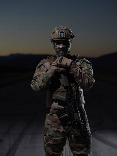 istock soldier with full combat gear in night mission 1307545483