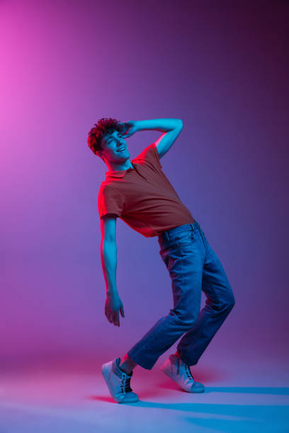 istock Happy man in casual clothes isolated on gradient background in neon light 1307545575
