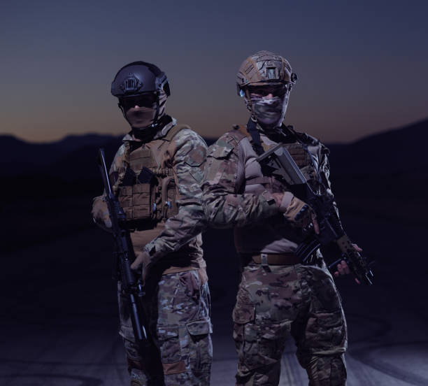 istock soldiers squad in night mission 1307545577