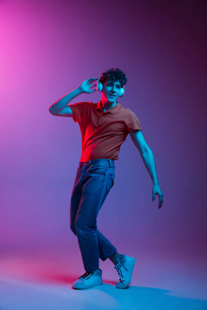 istock Happy man in casual clothes isolated on gradient background in neon light 1307545588