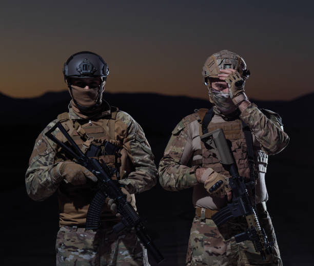 istock soldiers squad in night mission 1307545677