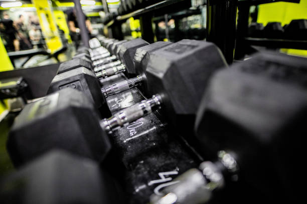 istock Dumbbells on rack in gym 1307546902