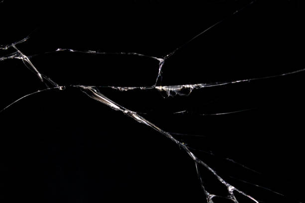 cracked glass on a black background closeup - cracked imagens e fotografias de stock