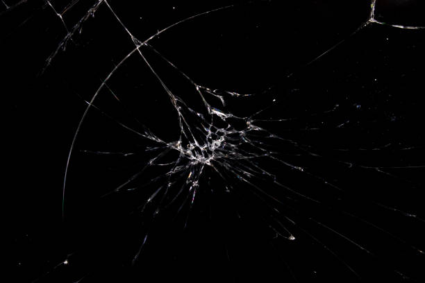 istock Cracked glass on a black background closeup 1307547451