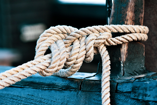 Ship rigging, shrouds of an old wooden ship. Old wooden deadeye on the shrouds of a sailing vessel of the nineteenth century