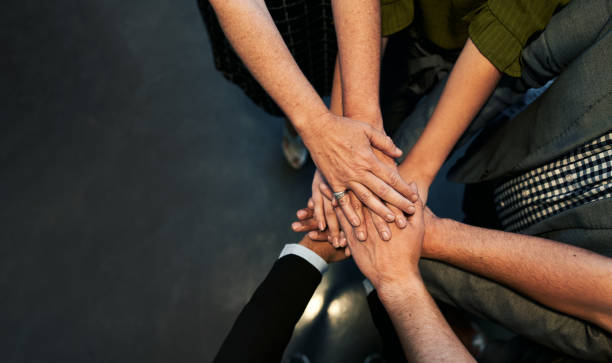 istock High angle view of business team stacking hands 1307548549