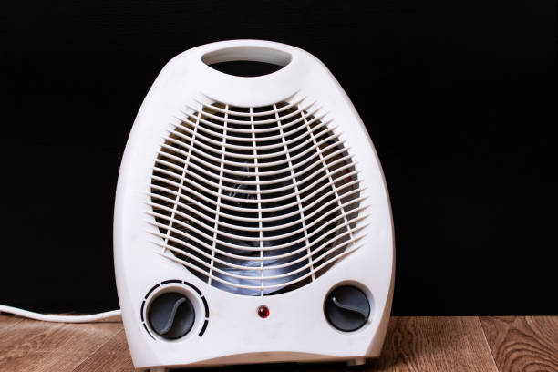 istock White fan heater on a wooden floor 1307548568