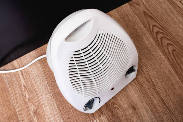 istock White fan heater on a wooden floor 1307548597