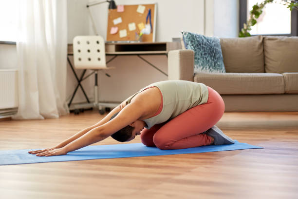 istock woman doing yoga child's pose at home 1307549845