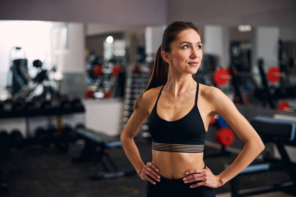 istock Young pretty female keeping hands on her waist 1307550231