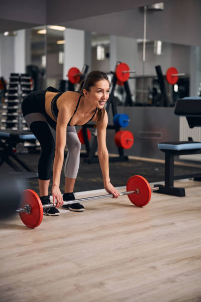 istock Charming brunette female preparing for lifting weights 1307550294