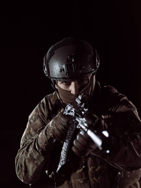 istock soldier with full combat gear in night mission 1307550373