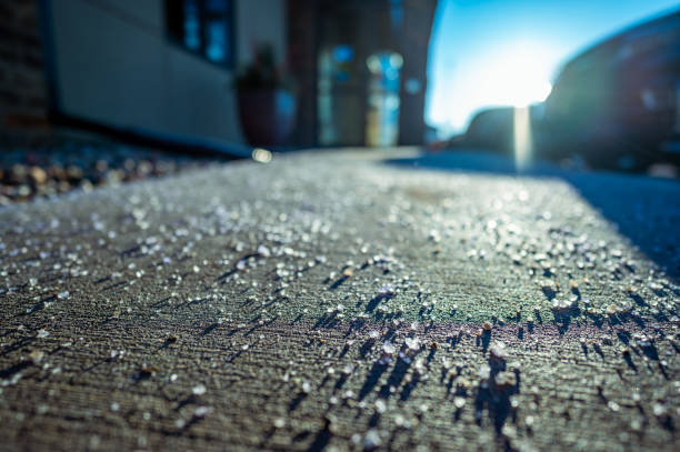low angle focus on salt on a sidewalk to melt snow and ice