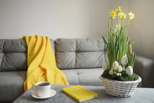 istock Spring home interior with Easter tree and vase with painted eggs. Quarantine. Self isolation. Domestic life. 1307552347