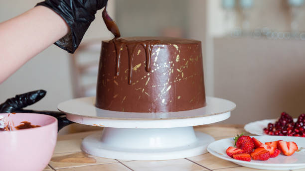 istock A pastry chef decorates a chocolate cake with glaze drips 1307552485