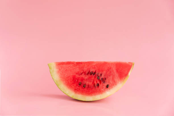 istock Slice of watermelon isolated on pink background 1307552777