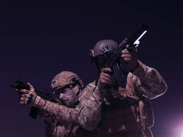 istock soldiers squad in night mission 1307552782