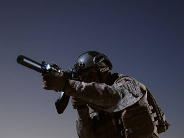 istock soldier with full combat gear in night mission 1307552845