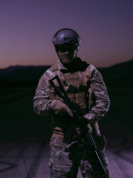 istock soldier with full combat gear in night mission 1307553441