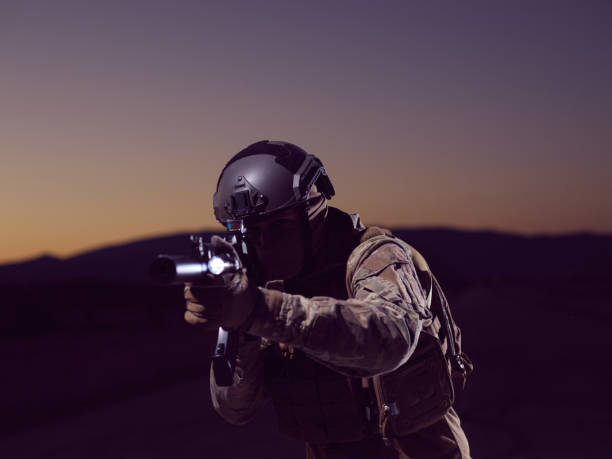 istock soldier with full combat gear in night mission 1307553471