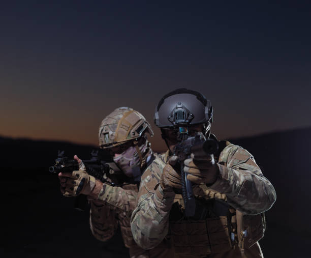 istock soldiers squad in night mission 1307553606