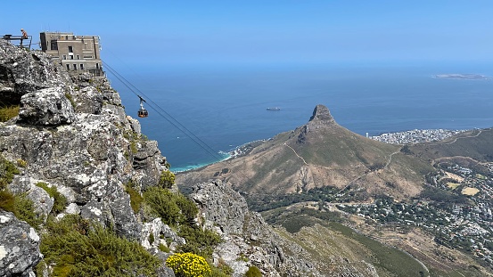 View of cable car and cable station, Lion’s Head, Robben Island an Cape Town from Table Mountain
