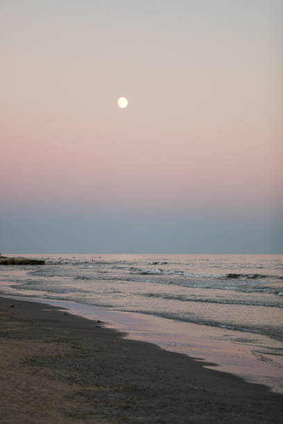 istock Full moon over the evening sea 1307555247
