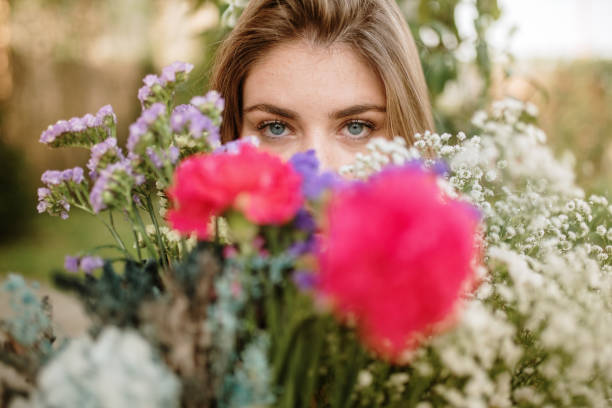 istock Young woman holding a flower bouquet 1307555438