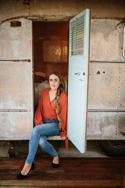 istock Young woman sitting in a motor home 1307557009