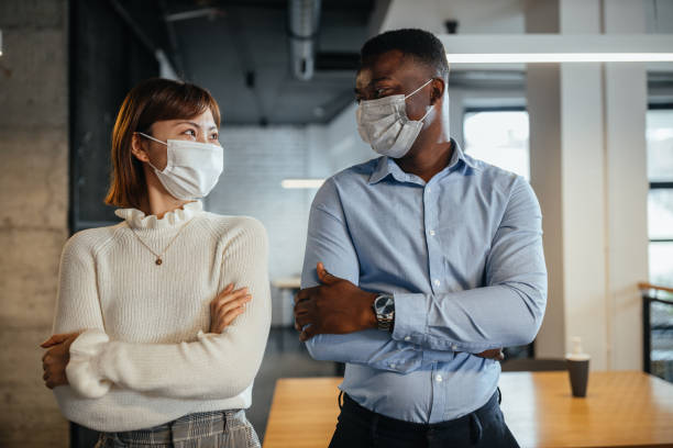istock Coworkers wearing protective medical masks 1307557748