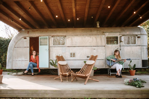 istock Two young sister sitting by a motor home 1307557756