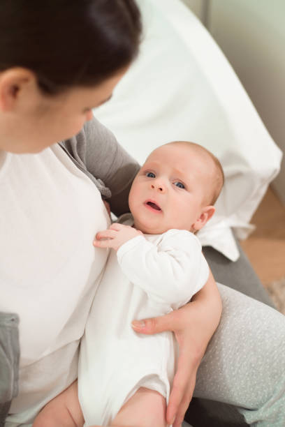 istock A small baby cries in her mother arms. 1307559187
