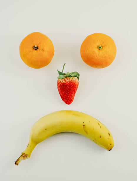 istock happy and sad faces made with fruit 1307559450