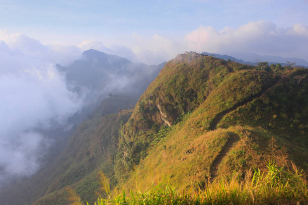 istock fog was moving between the top of mountain while sunlight effect to a mountain 1307559459
