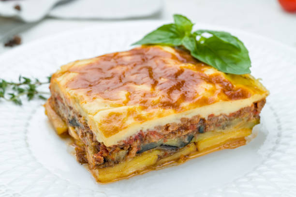 istock Eggplant moussaka Greek cuisine on white plate on white concrete table 1307559589