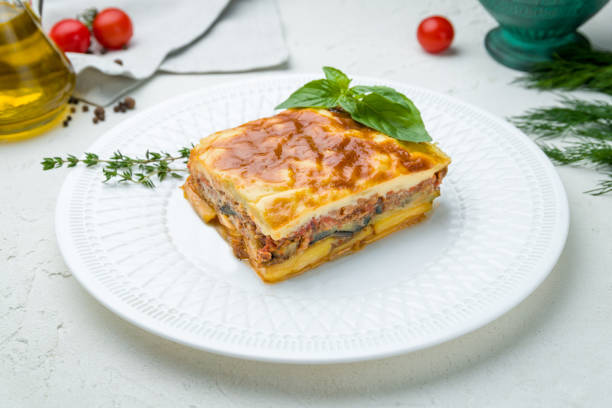 istock Eggplant moussaka Greek cuisine on white plate on white concrete table 1307560381