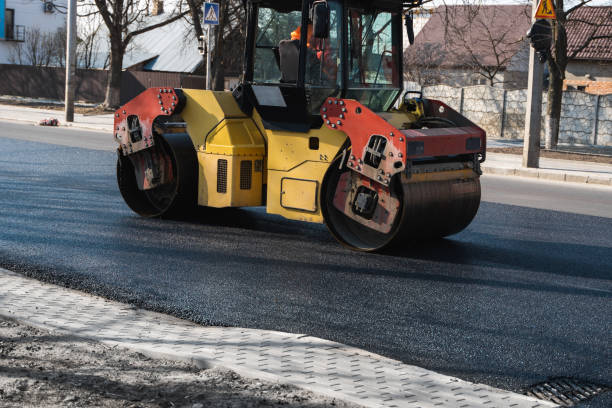 istock Asphalt road roller with heavy vibration roller compactor press new hot asphalt on the roadway on a road construction site. Heavy Vibration roller at asphalt pavement working. Repairing. 1307561384