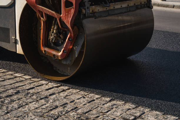 istock Asphalt road roller with heavy vibration roller compactor press new hot asphalt on the roadway on a road construction site. Heavy Vibration roller at asphalt pavement working. Repairing. 1307561929