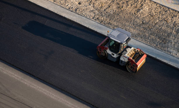 istock Asphalt road roller with heavy vibration roller compactor press new hot asphalt on the roadway on a road construction site. Heavy Vibration roller at asphalt pavement working. Repairing. 1307562859