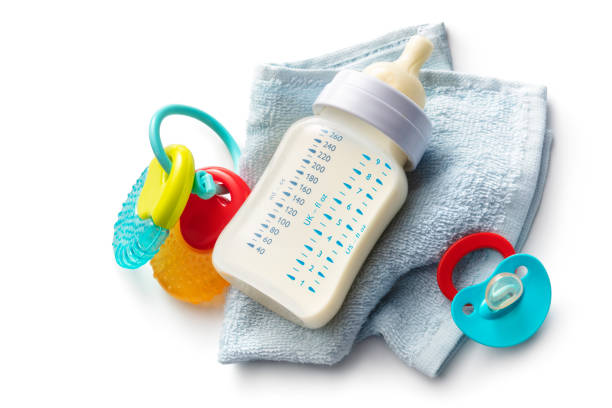 Cute baby boy reaching a floating milk bottle.