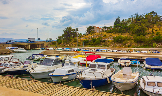 Beach at the marina beach promenade with boats in Novi Vinodolski Croatia.