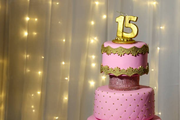 Party Cake, 15th Birthday Cake, Fifteen Years Pink party cake, 15th birthday, with golden number fifteen, pink cake, 15 year old birthday cake bottom the weaver stock pictures, royalty-free photos & images